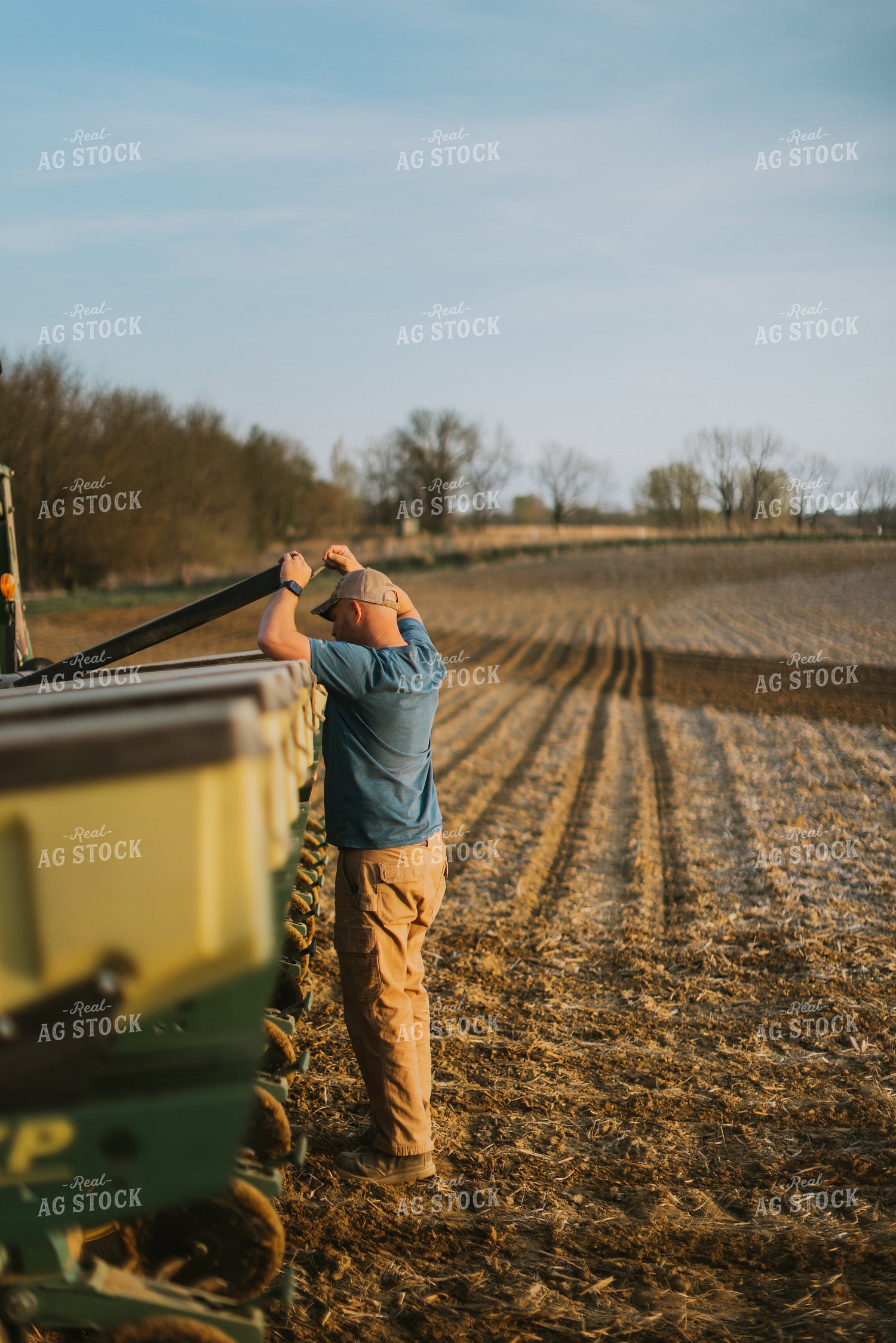 Farmer Checking Seed Box on Planter 7449
