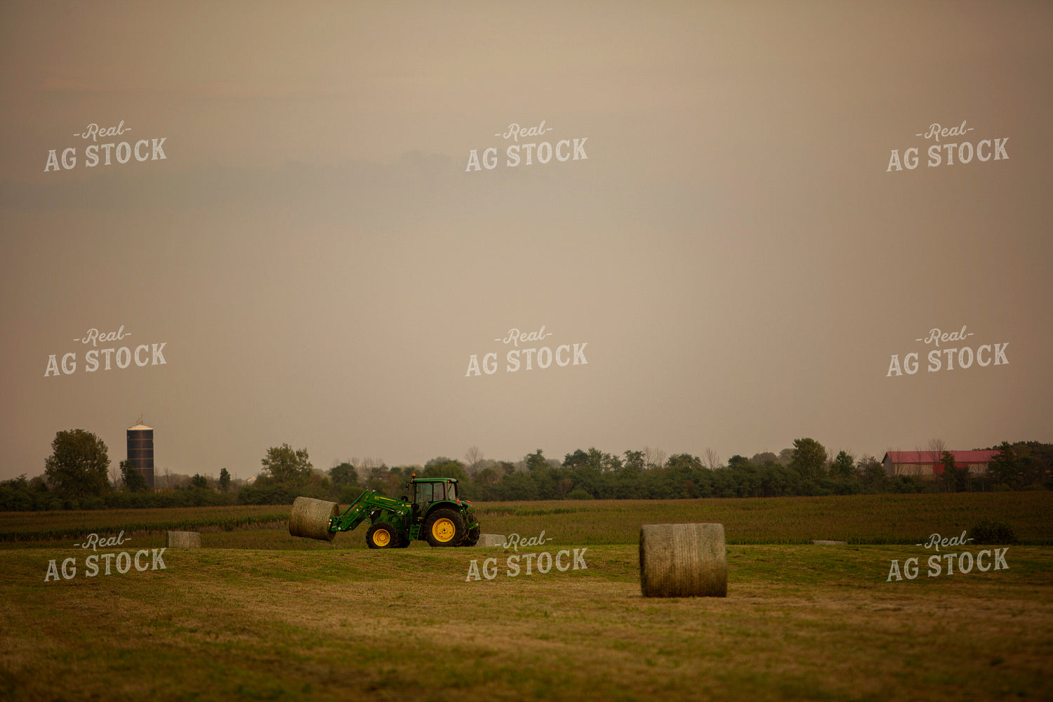 Tractor Lifting Round Hay Bale 5518