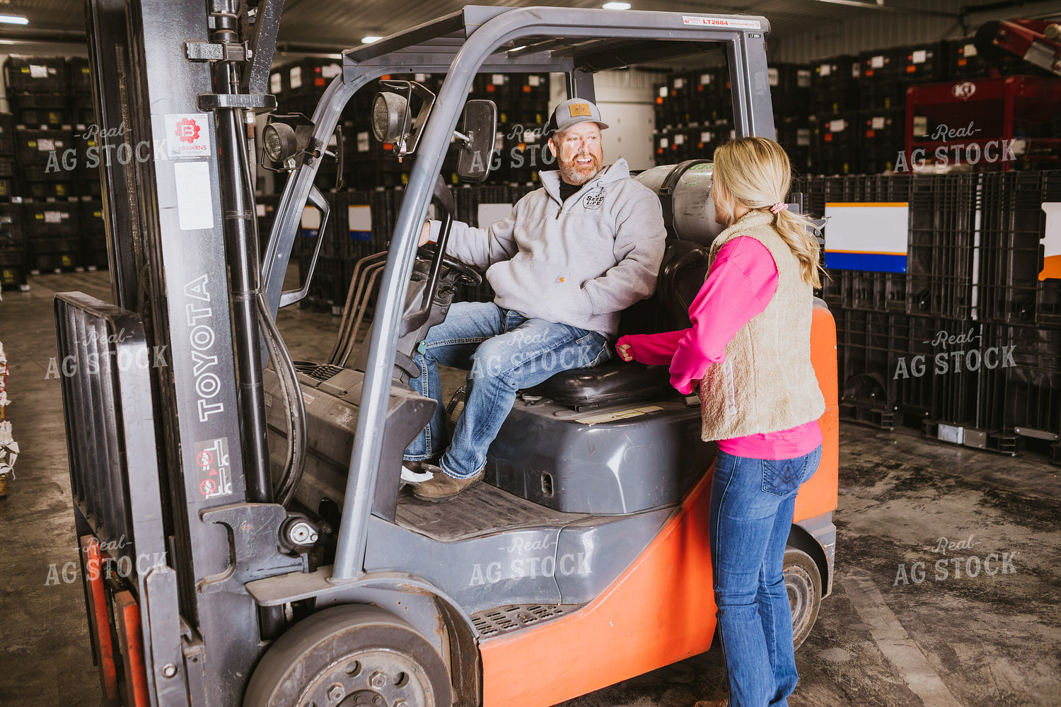 Forklift Operator Talking to Woman in Seed Warehouse 5346