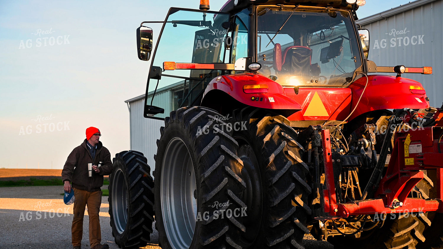 Farmer Climbing into Tractor Cab 25344