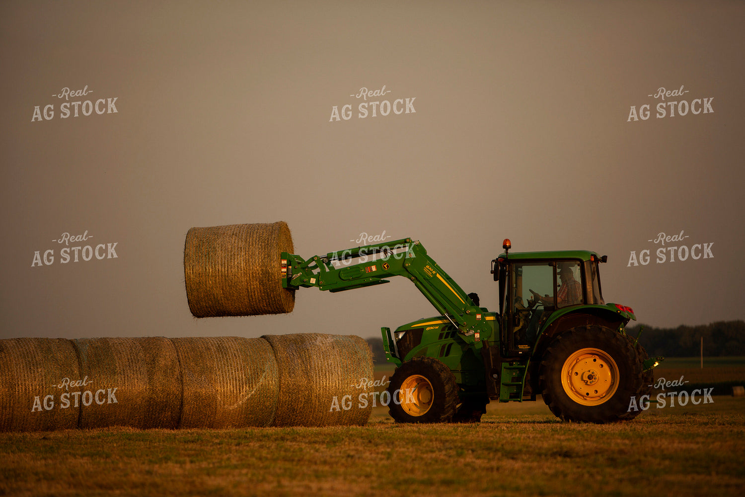 Tractor Lifting Round Hay Bale Overcast Sky 5525
