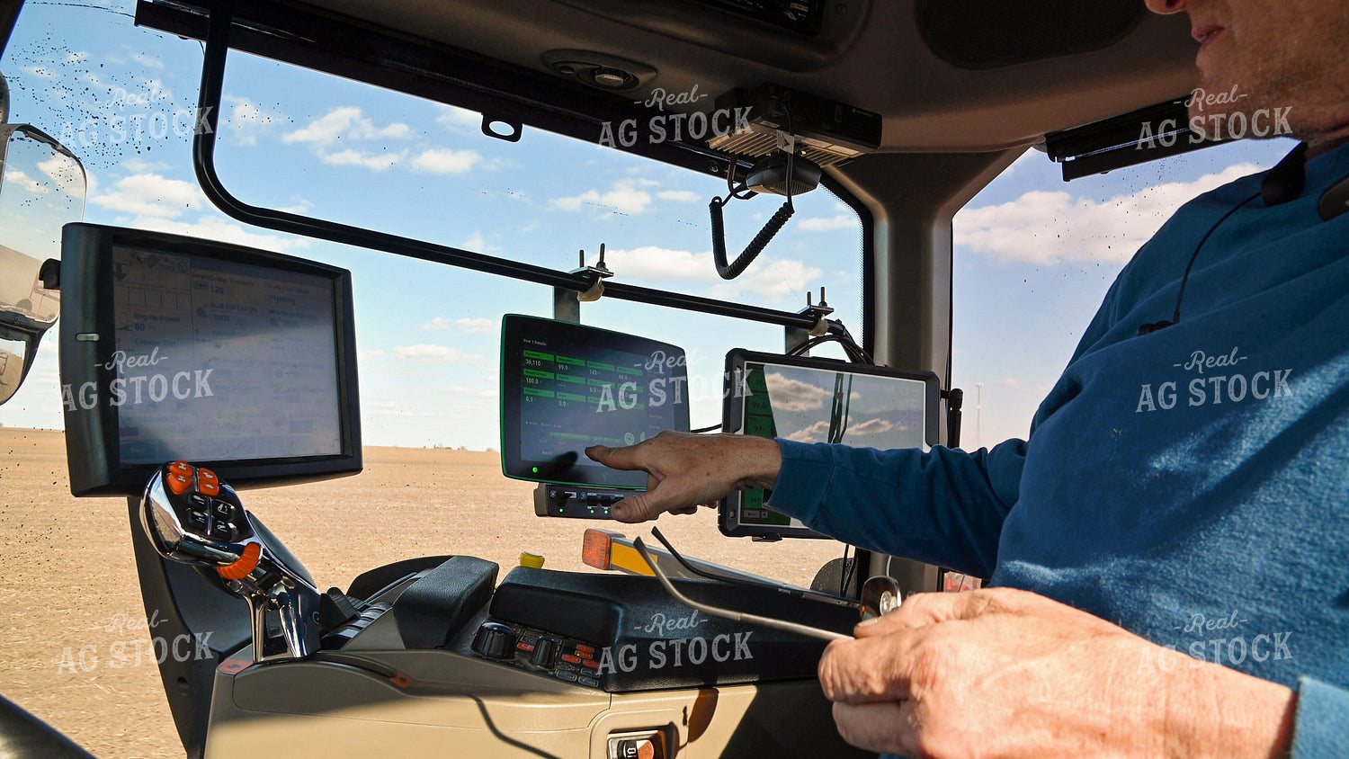 Farmer in the Tractor Cab with Technology 25233