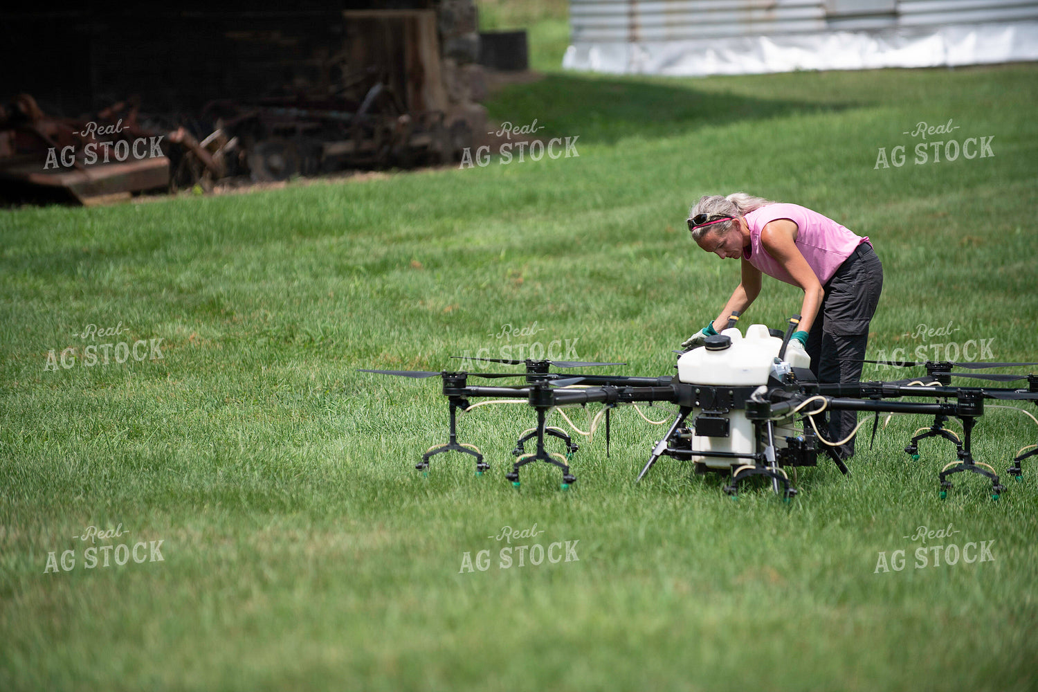 Female Pilot Preparing Drone for Fungicide Application 168072