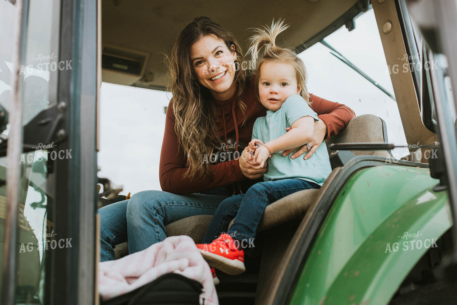 Female Farmer with Daugther in Tractor 8573