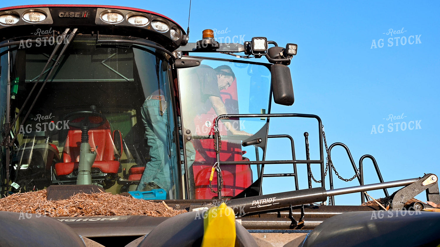Farmer Climbing Out of Combine Cab 25523