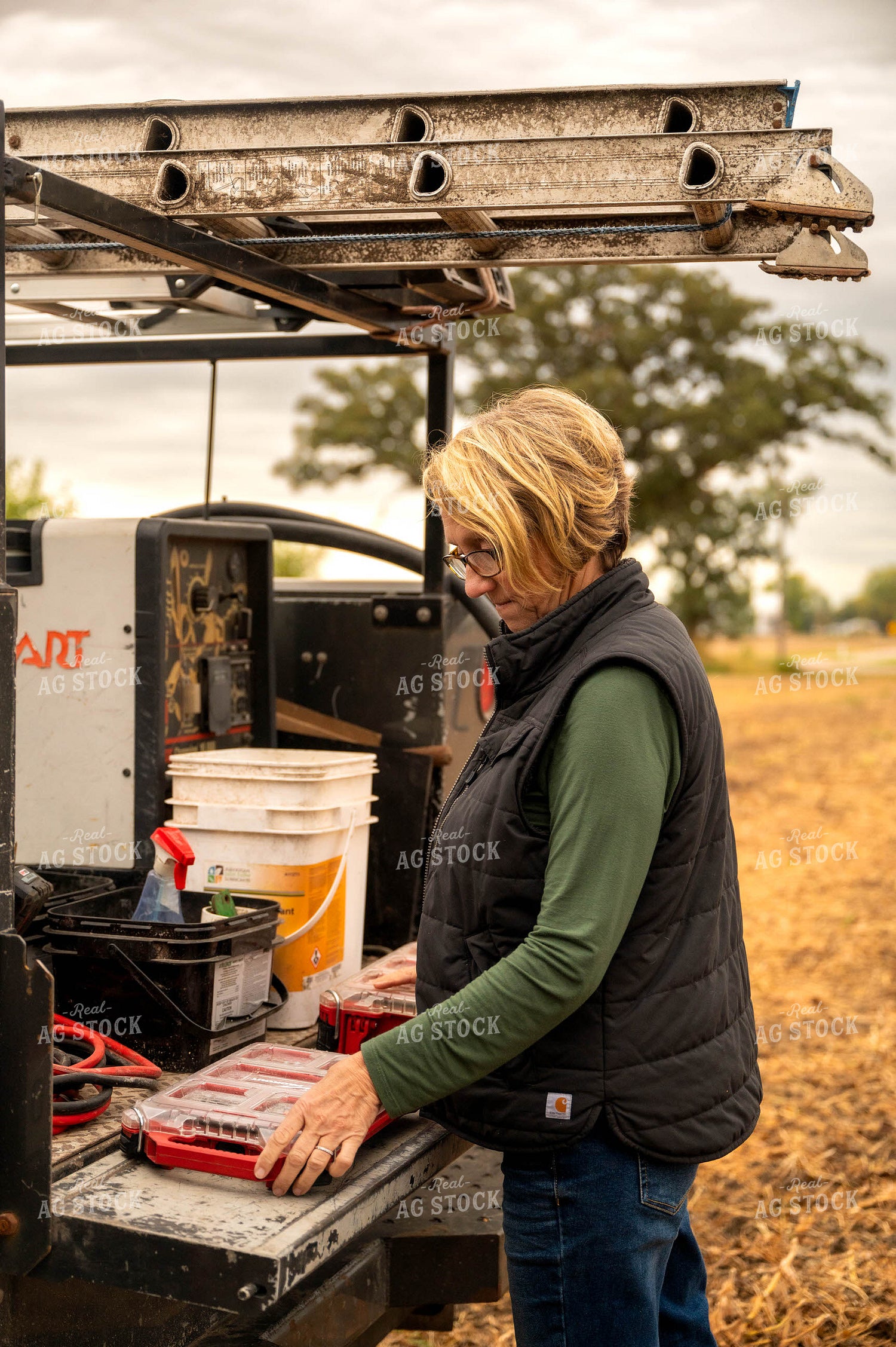 Female Farmer Getting Tools out of Service Truck 115416