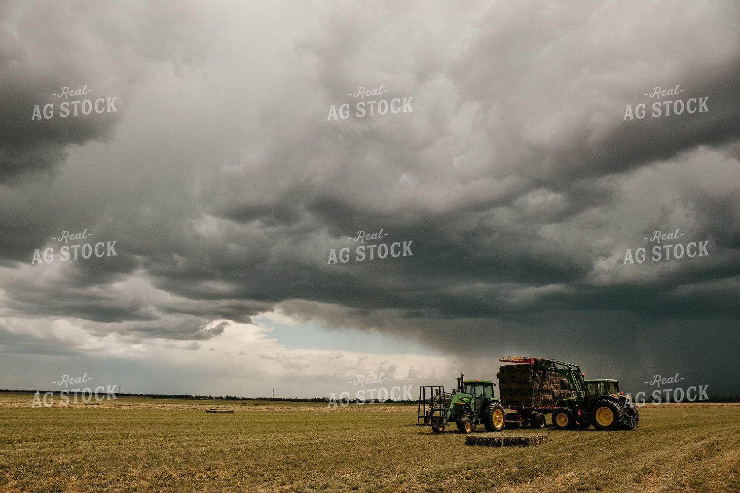 Loading Small Square Bales with Storm in Background 64007
