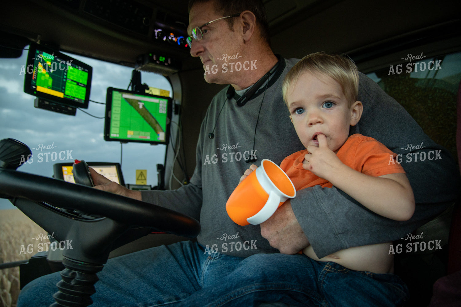 Grandson and Grandfather Farmer in the Combine Cab 25837