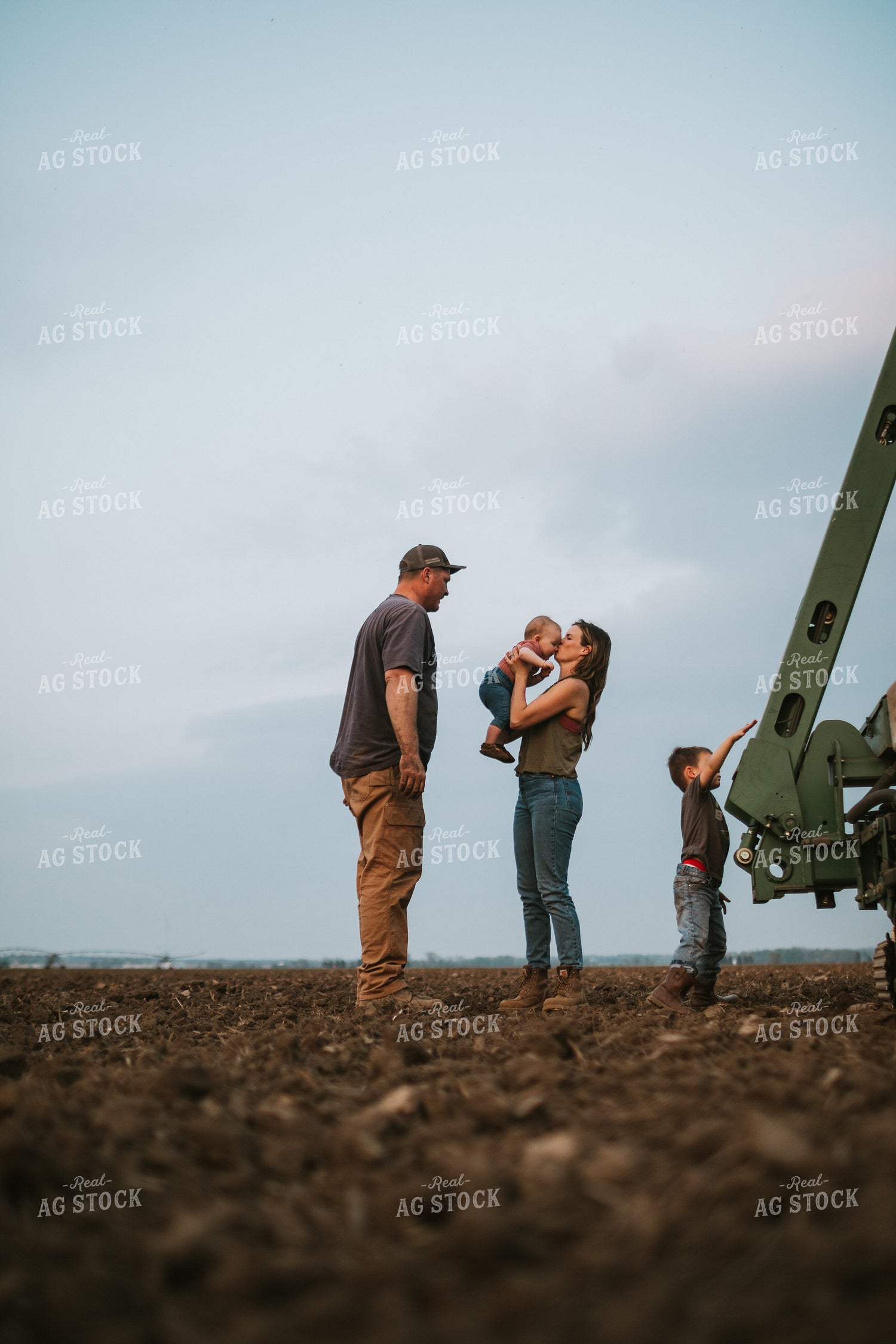 Farm Family in Field During Planting 5727
