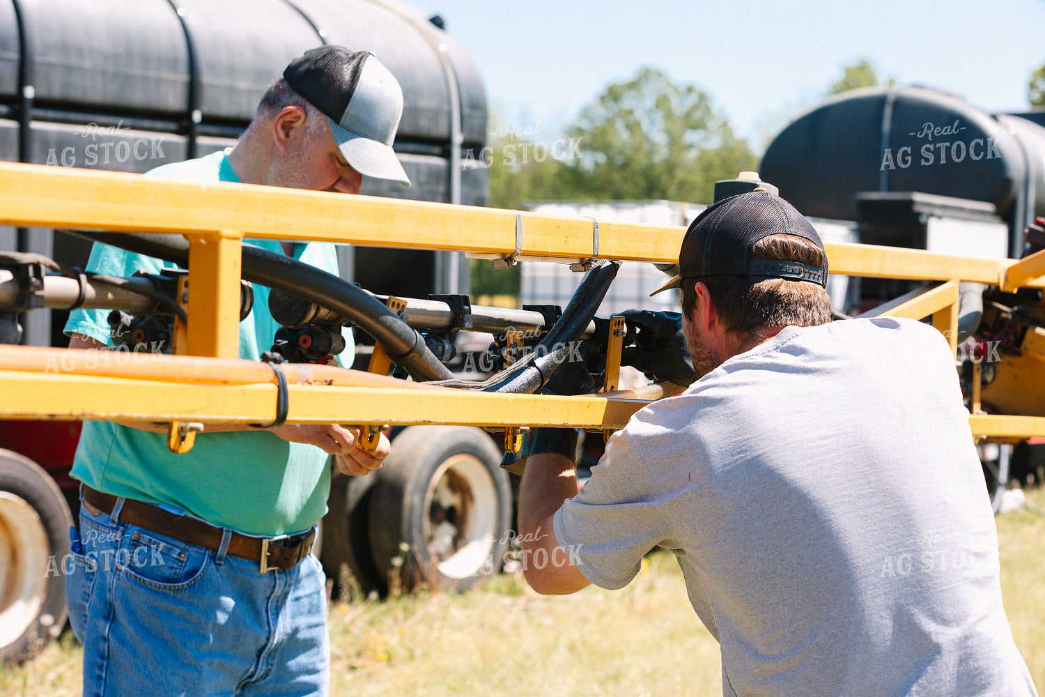 Farmer Fixing Sprayer Nozzles 52724