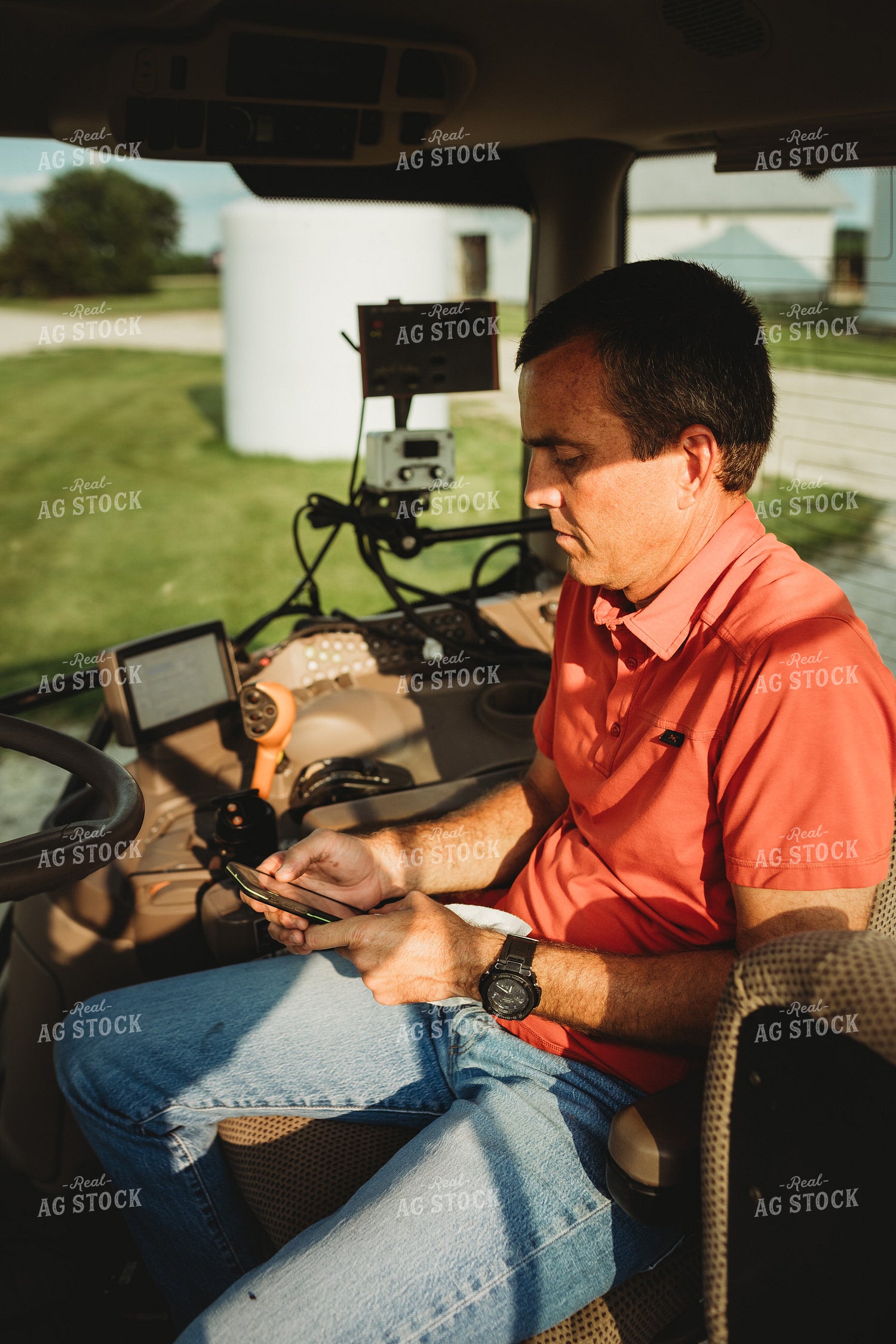 Farmer with Tractor Cab Monitors and Smart Phone 4464