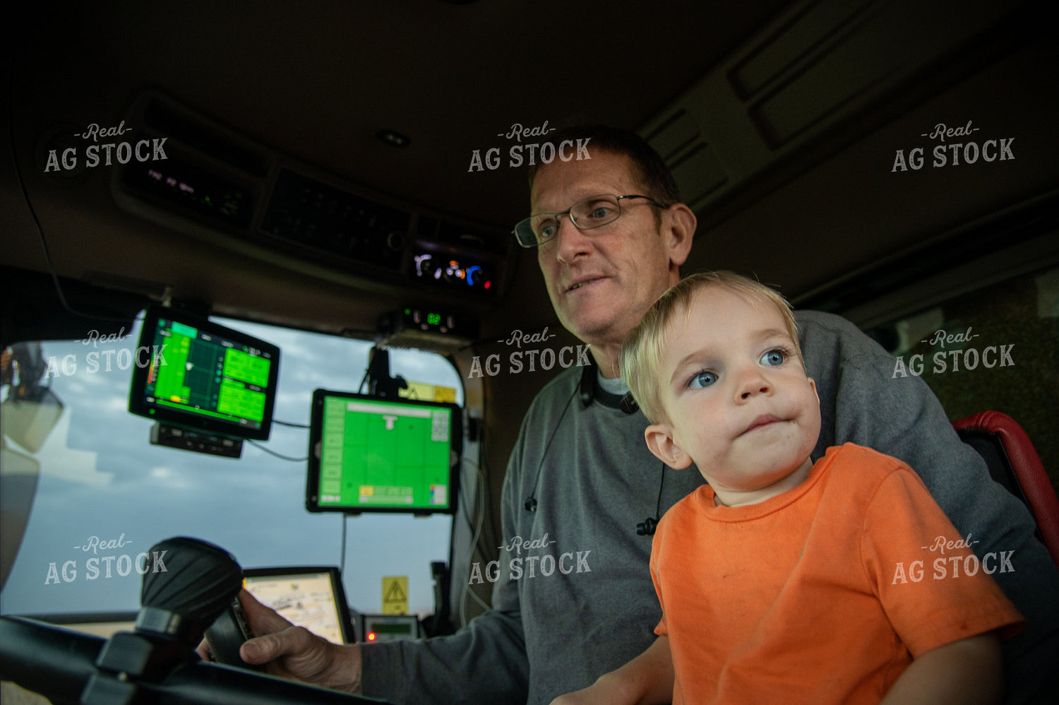 Grandson and Grandfather Farmer in the Combine Cab 25836