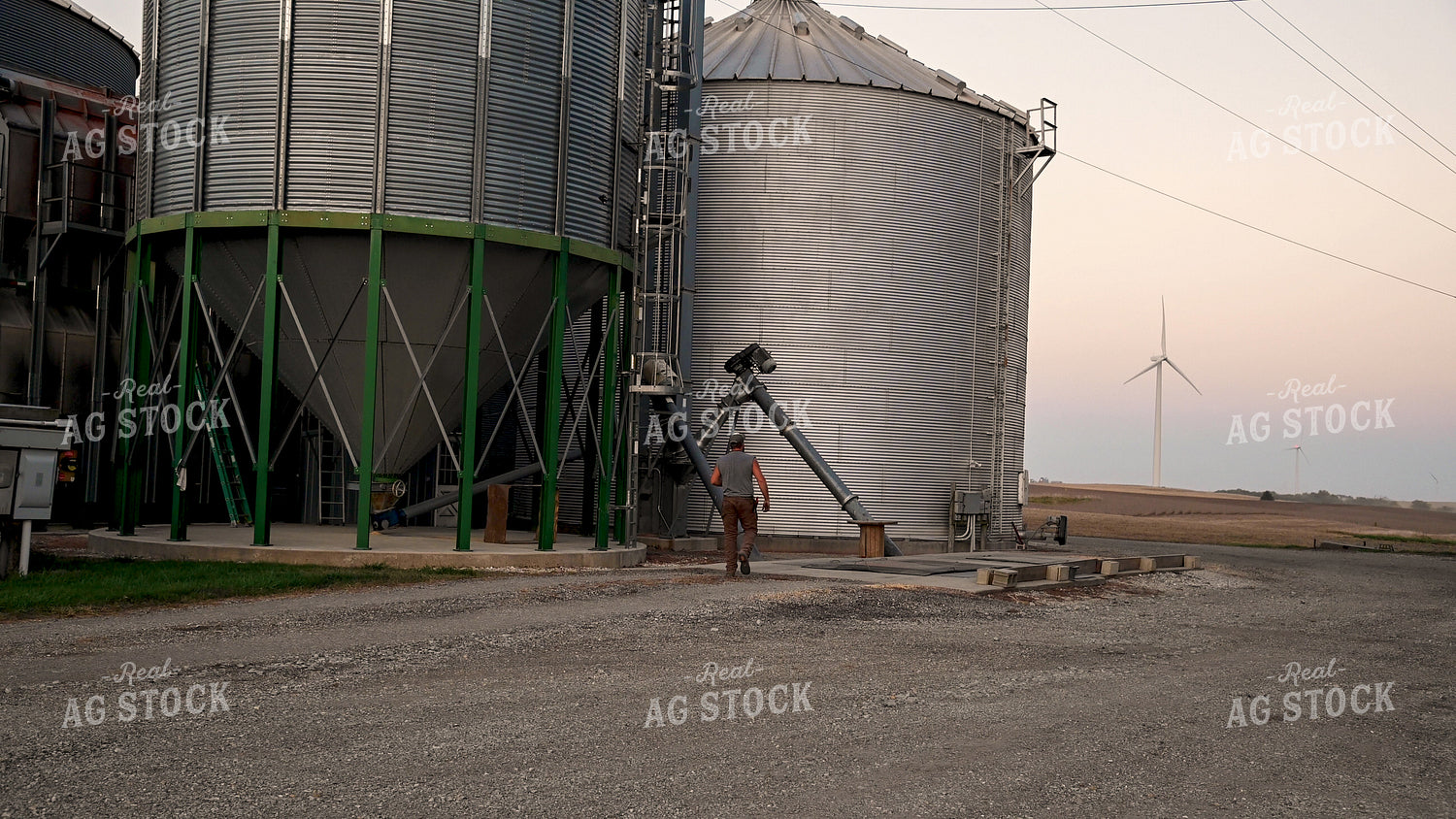 Farmer Working at Grain Bin Site during Harvest 25769