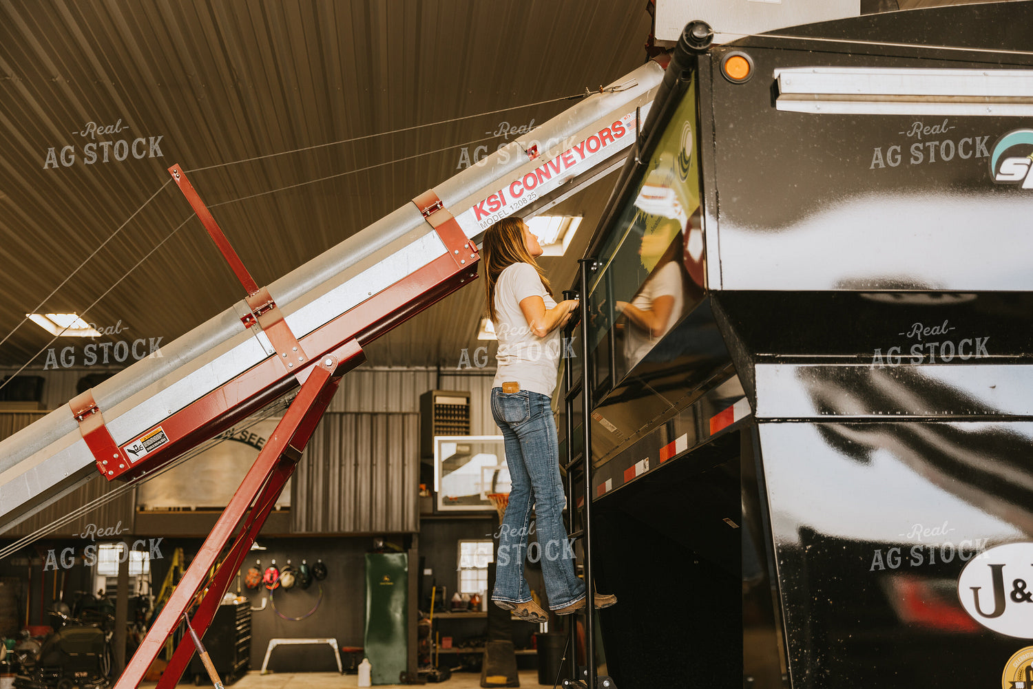 Woman Farmer Looks into Seed Tender Hopper 7588