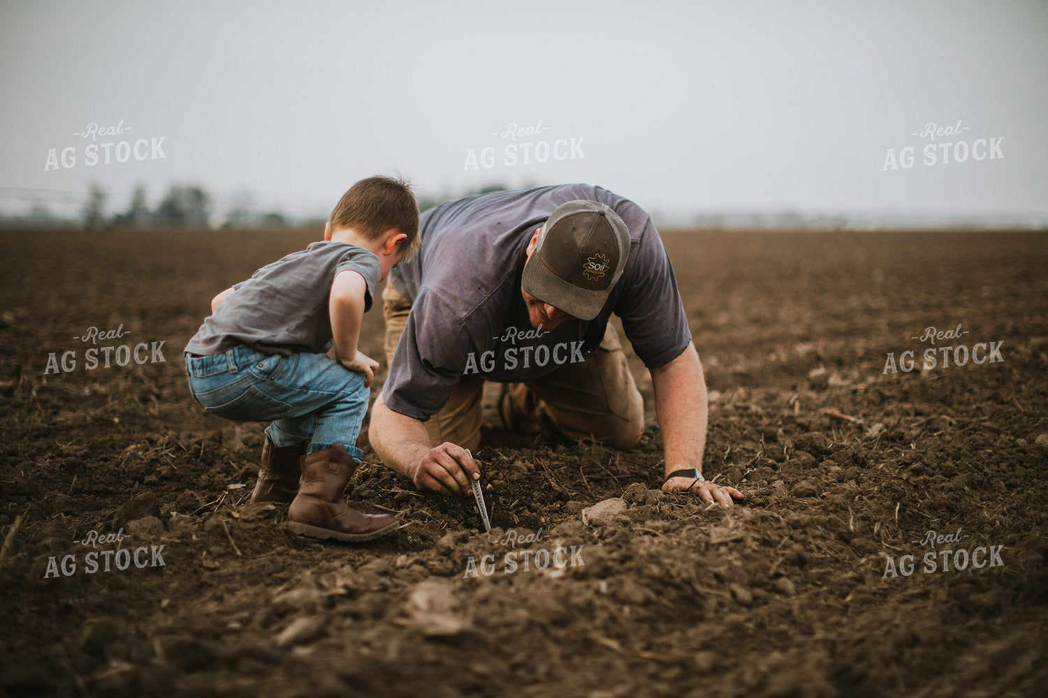 Farmer and Farm Kid Checking Seed Depth 5661