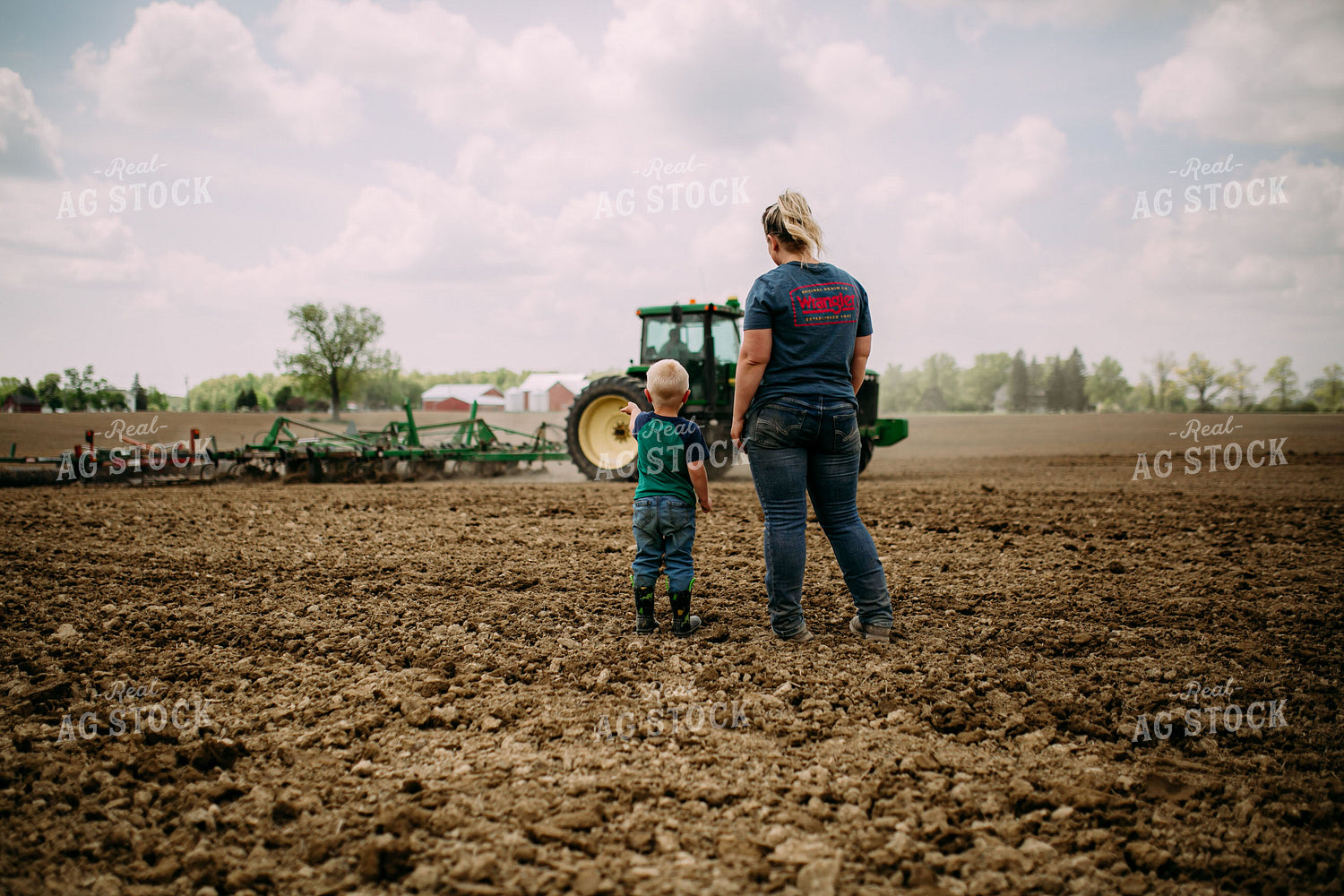 Farm Kid and Mom Watching Tractor in Field 169092