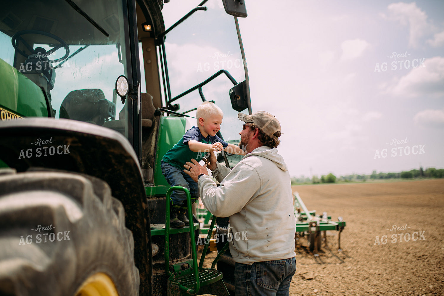Farmer Helping Son Out of Tractor 169079