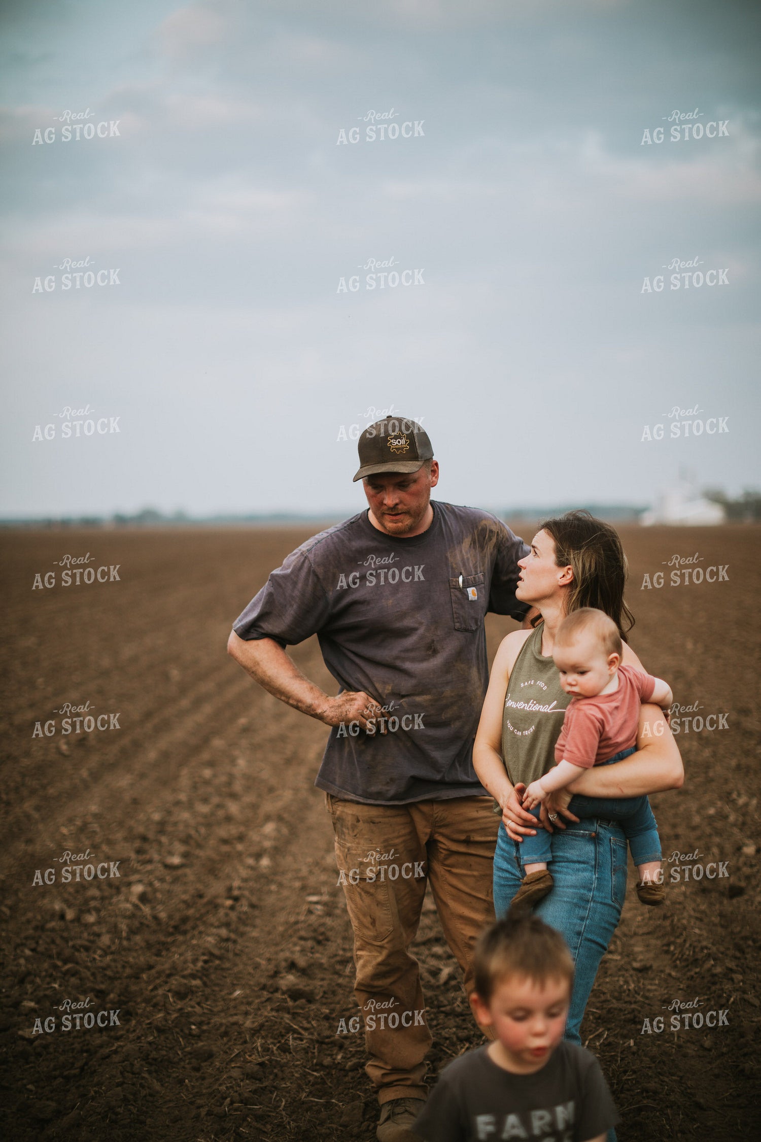 Farm Family in Field During Planting 5694