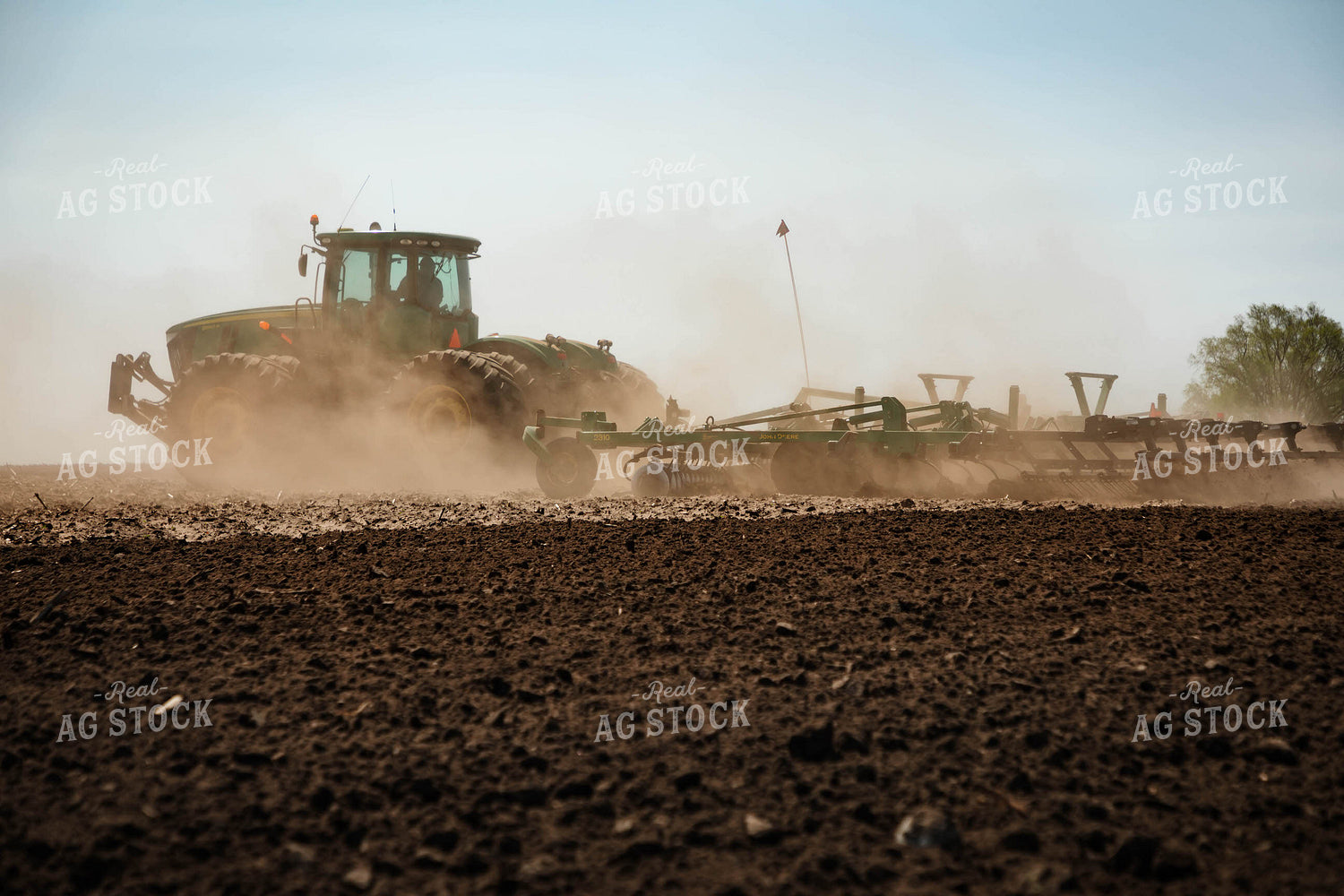 Large Tractor Plowing Field on a Dusty Spring Day 152486