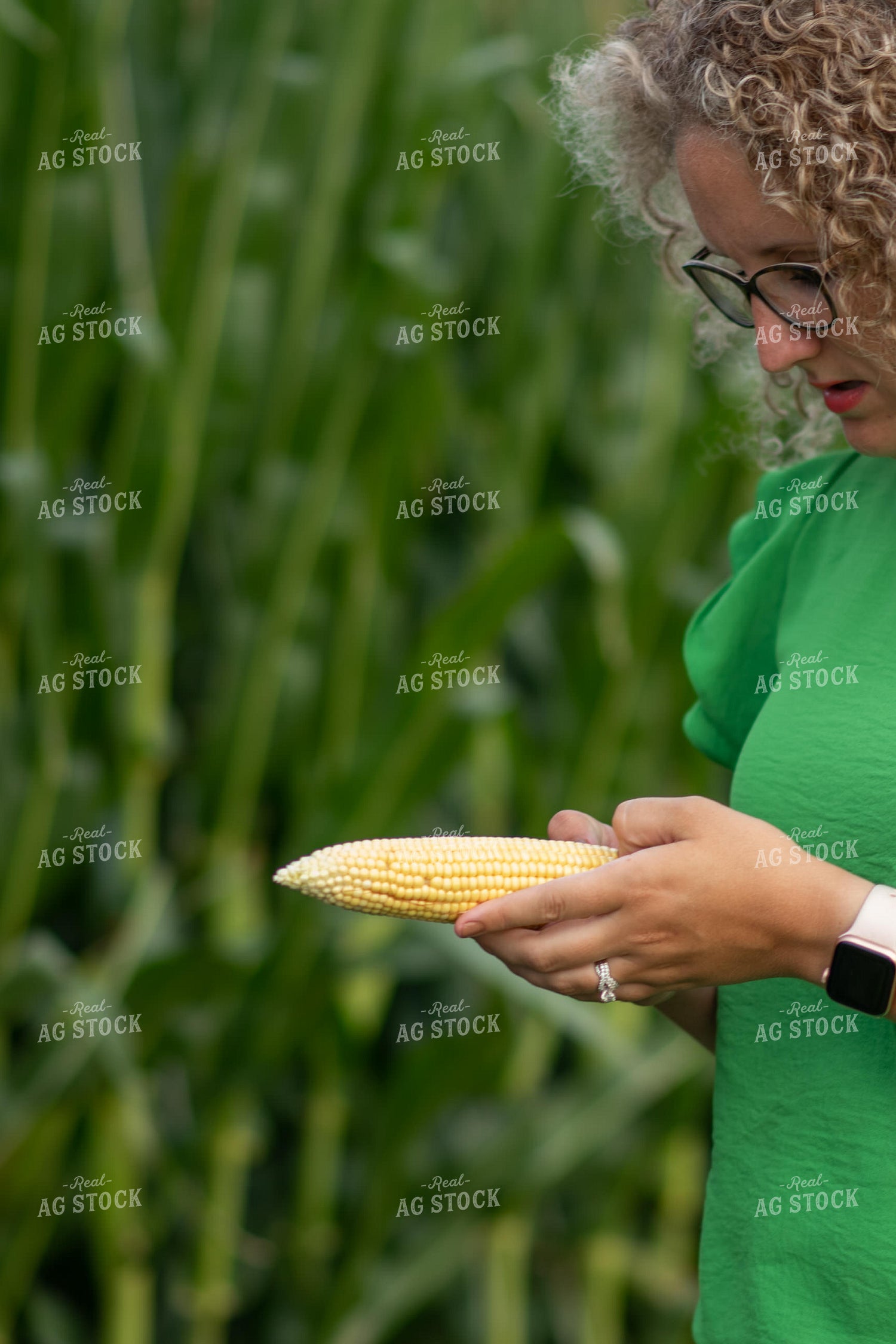 Female Farmer Holding Ear of Sweet Corn 76326