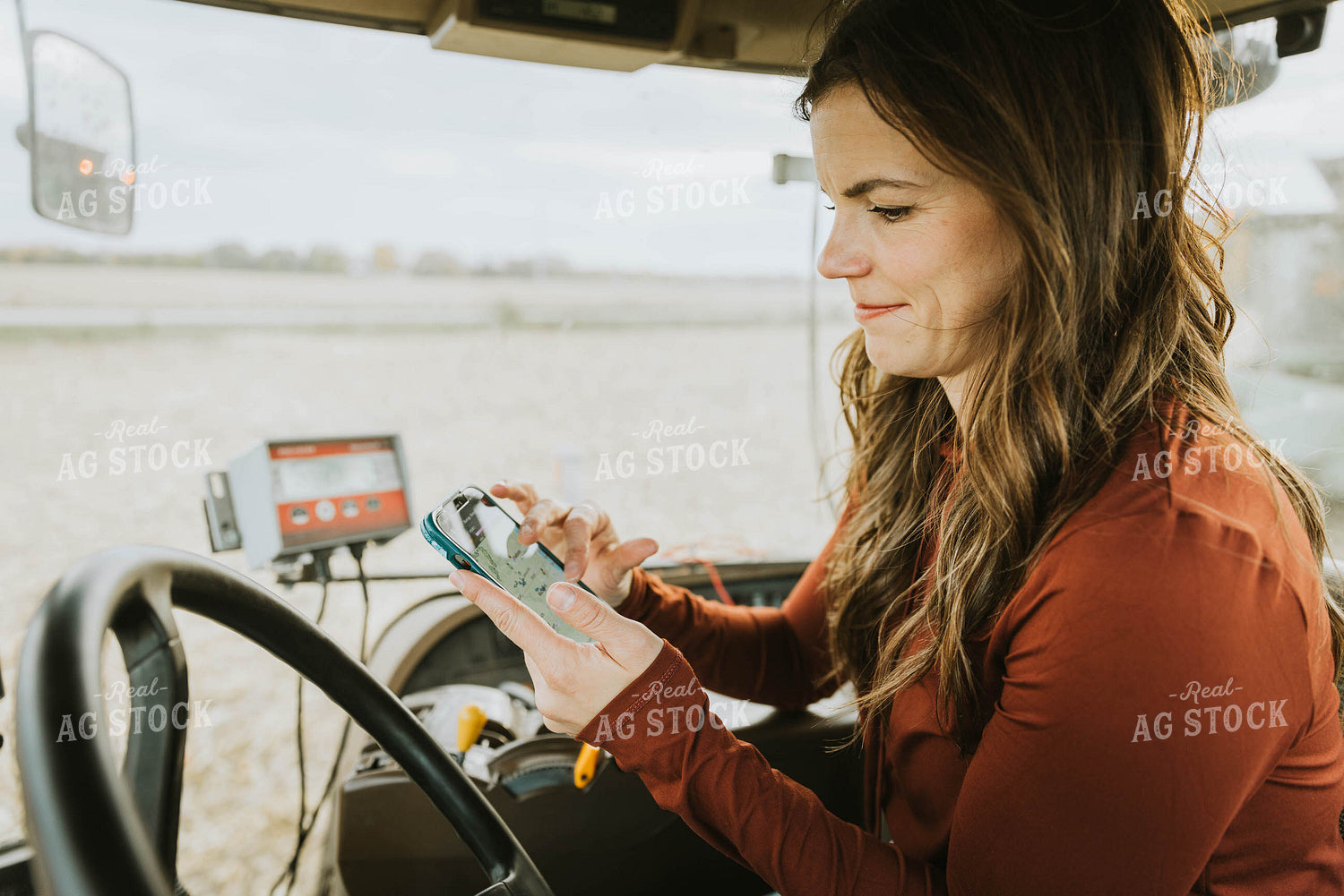 Female Farmer Using Phone in Tractor 8544