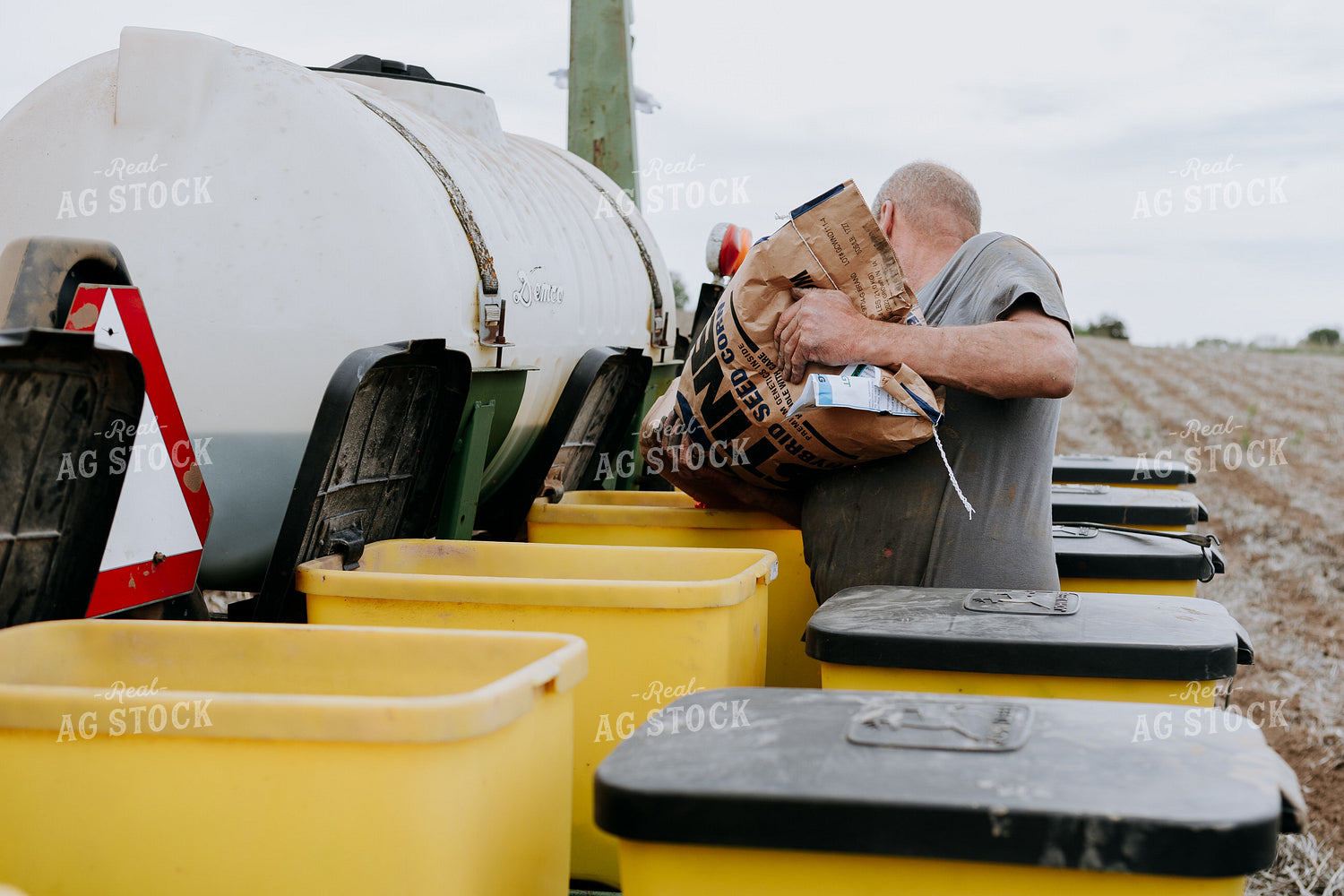 Farmer Filling Planter Boxes 77072