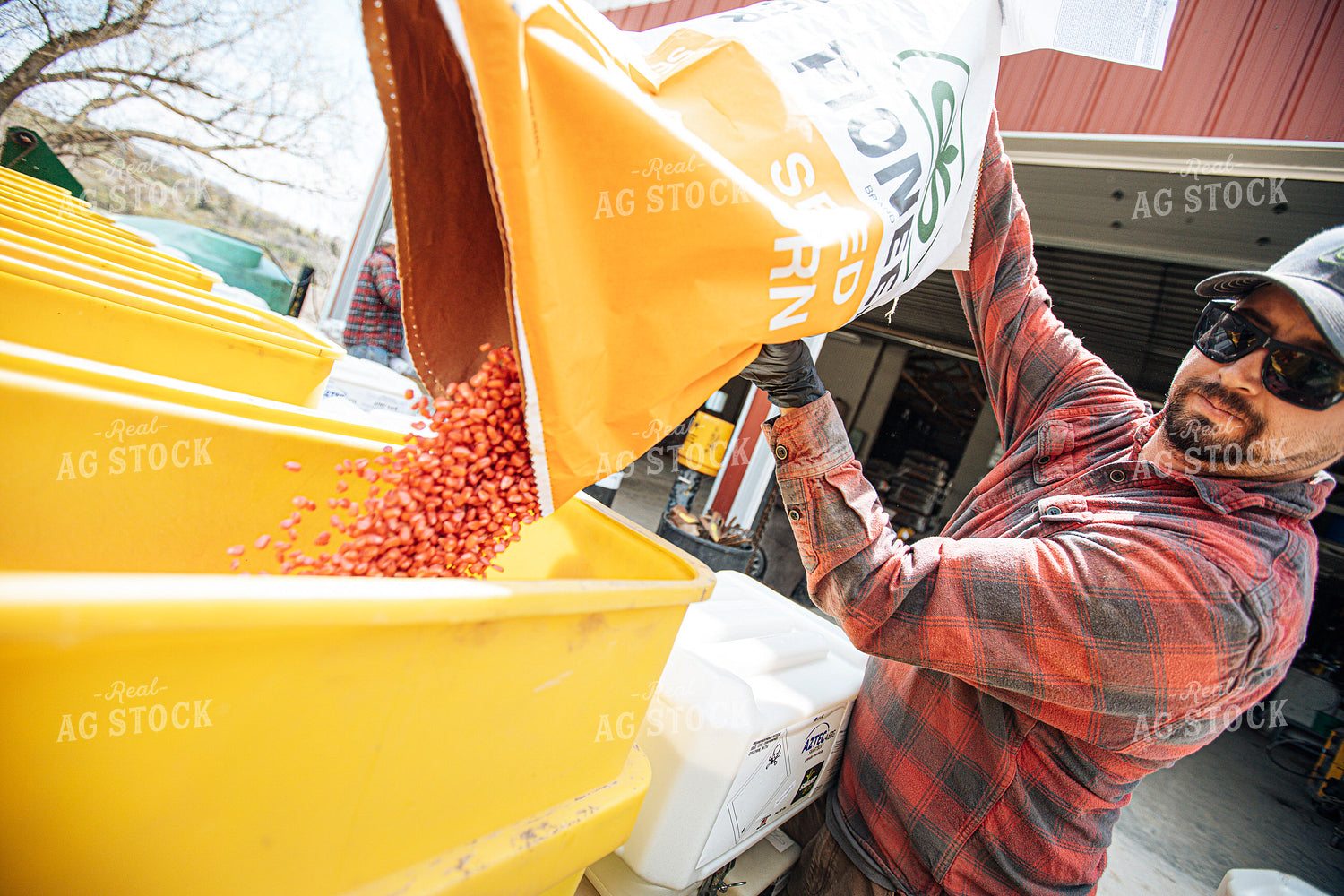 Farmer Filling Planter with Seed Bag 250160