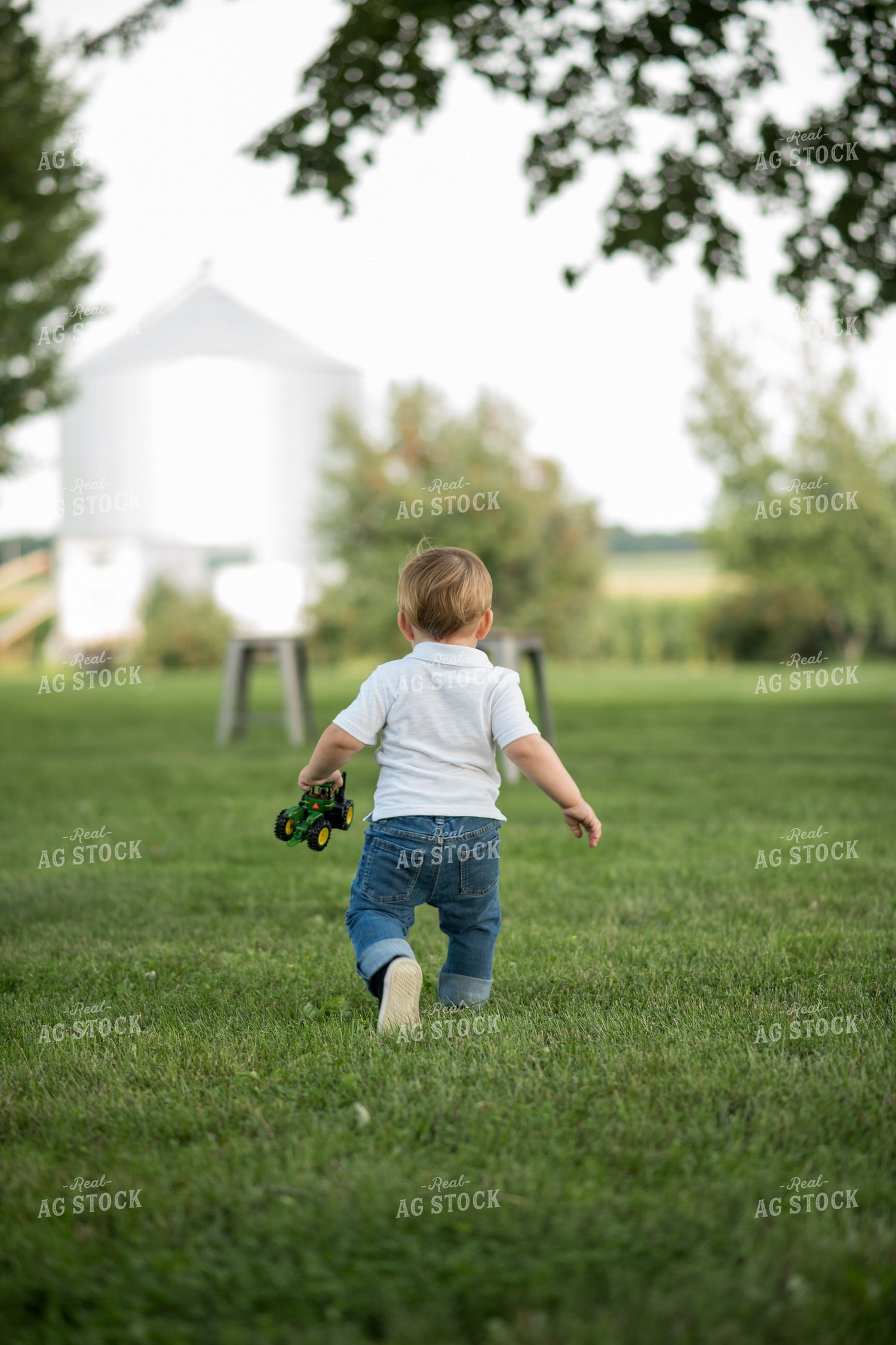 Farm Kid with Toy Tractor 76399