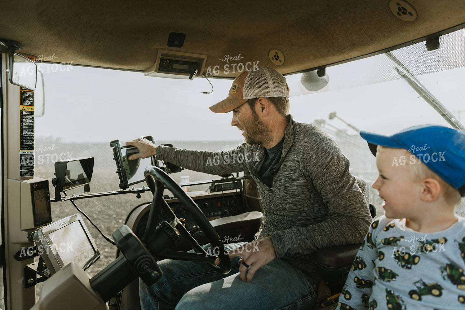 Farmer in Tractor Cab with Son 8183