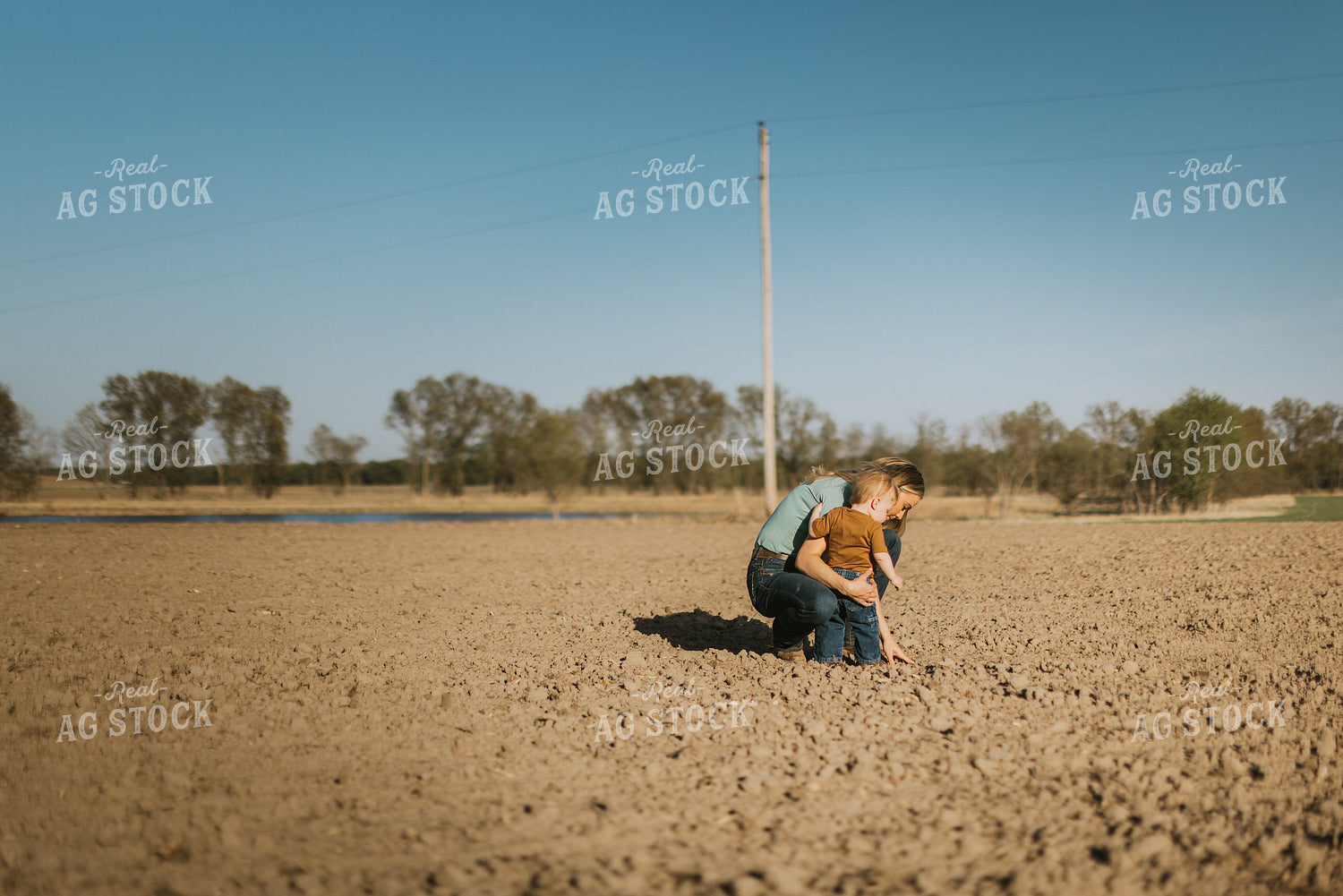 Farm Wife and Child Check Seed Depth During Planting 7640
