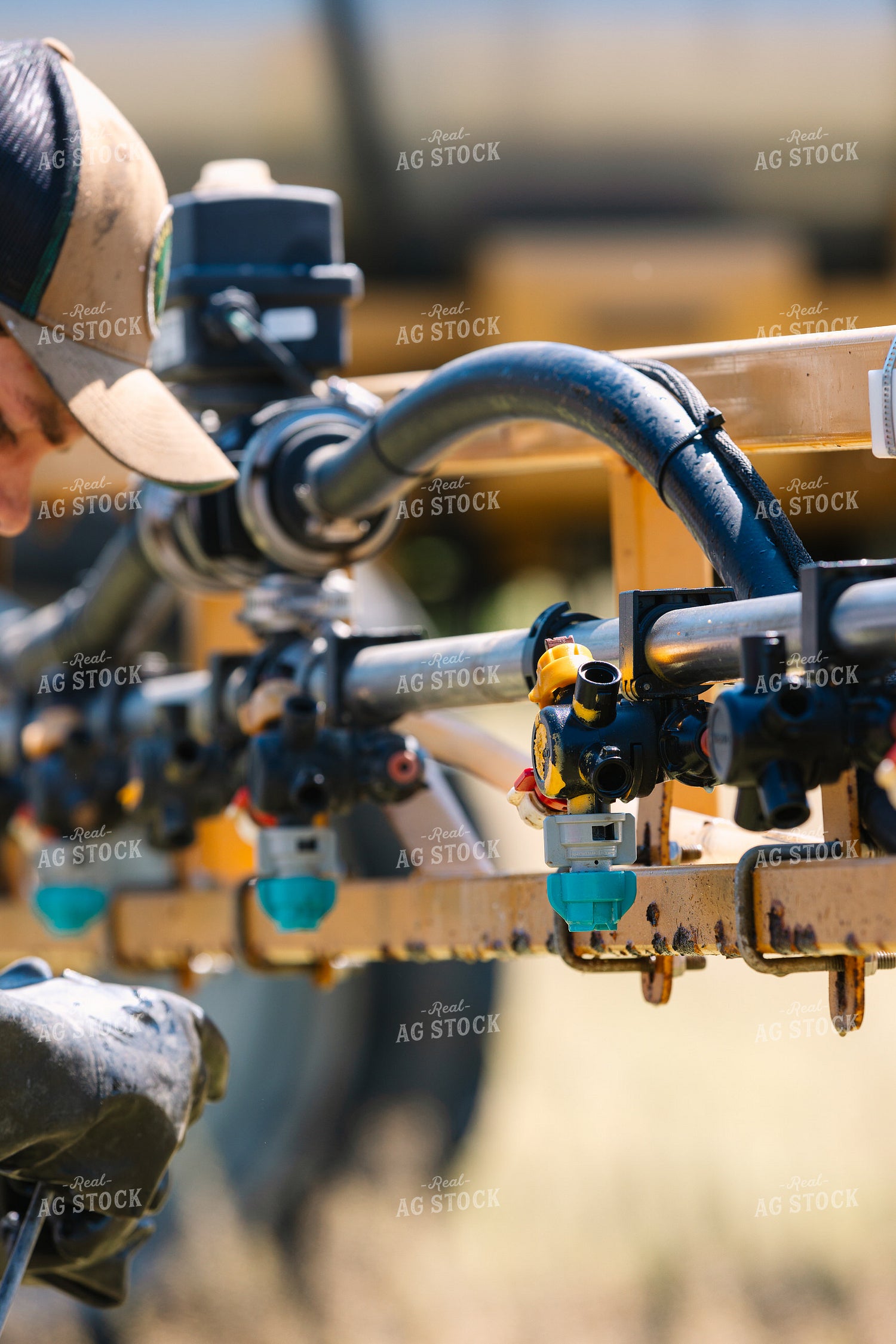 Farmer Fixing Sprayer Nozzles 52722