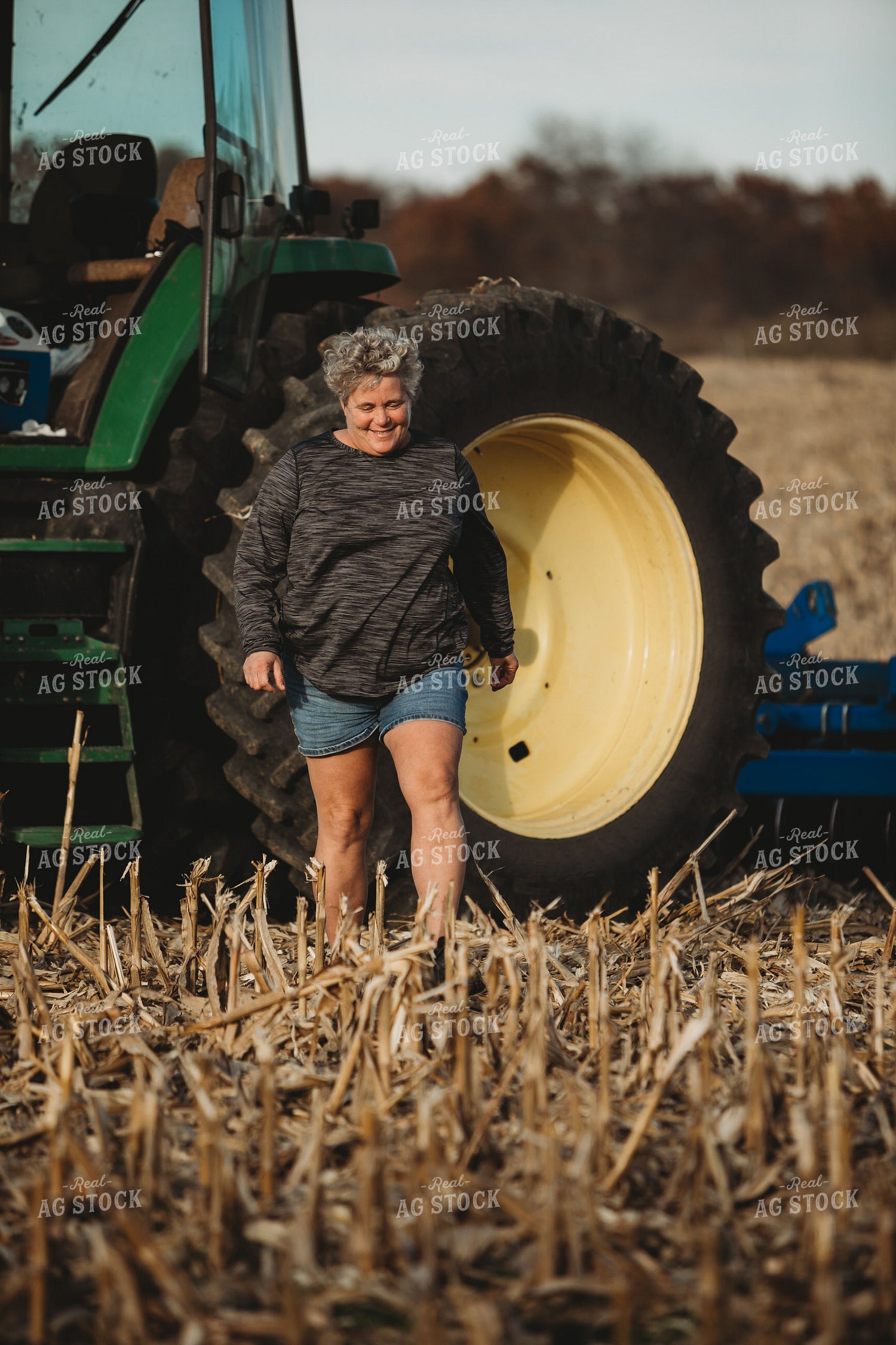 Female Farmer Getting out of Tractor with Disk 3624