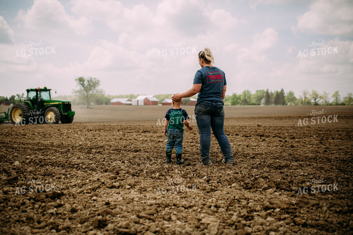 Farm Kid and Mom Watching Tractor in Field 169091