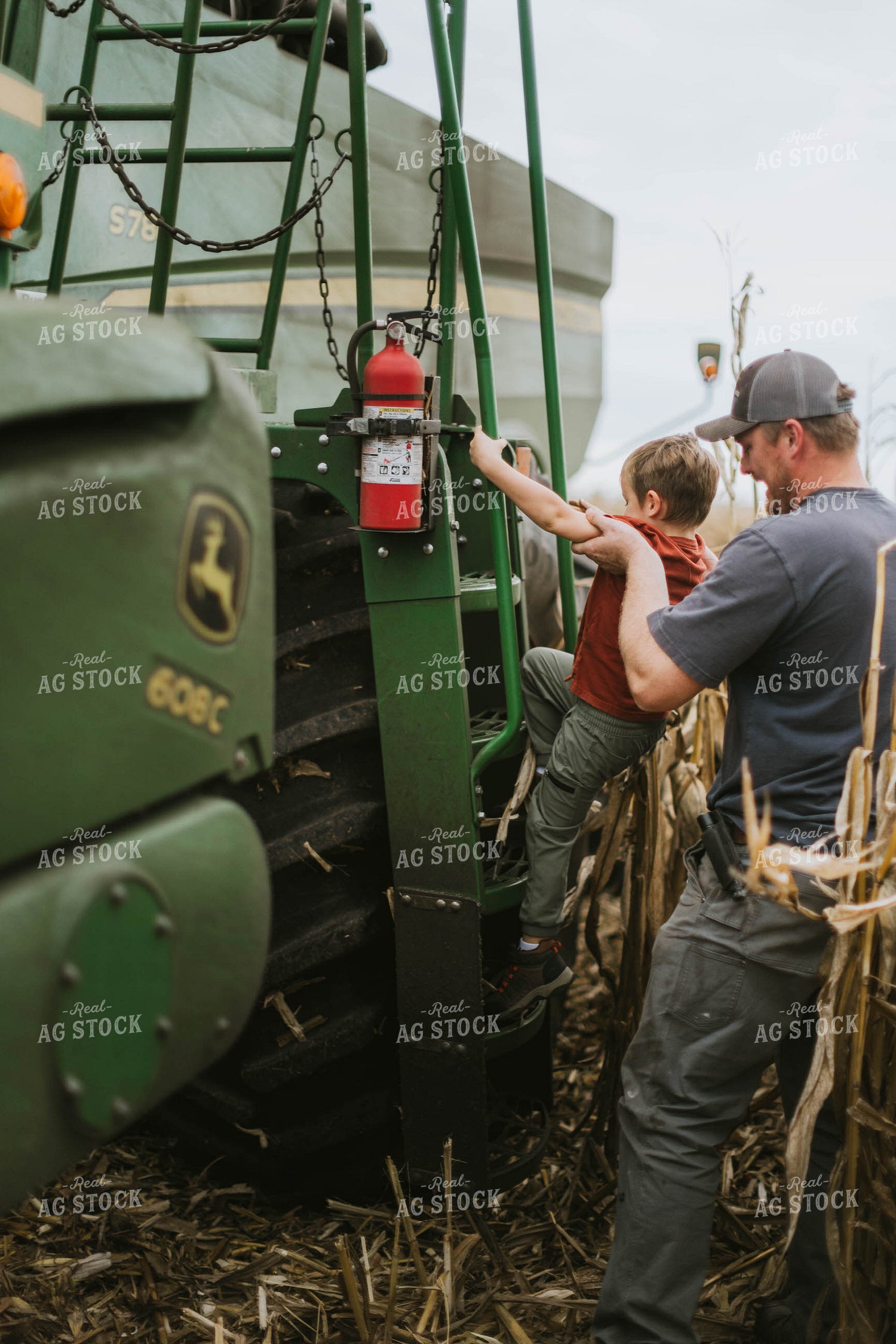 Farmer and Son Cimbing into Combine 8593