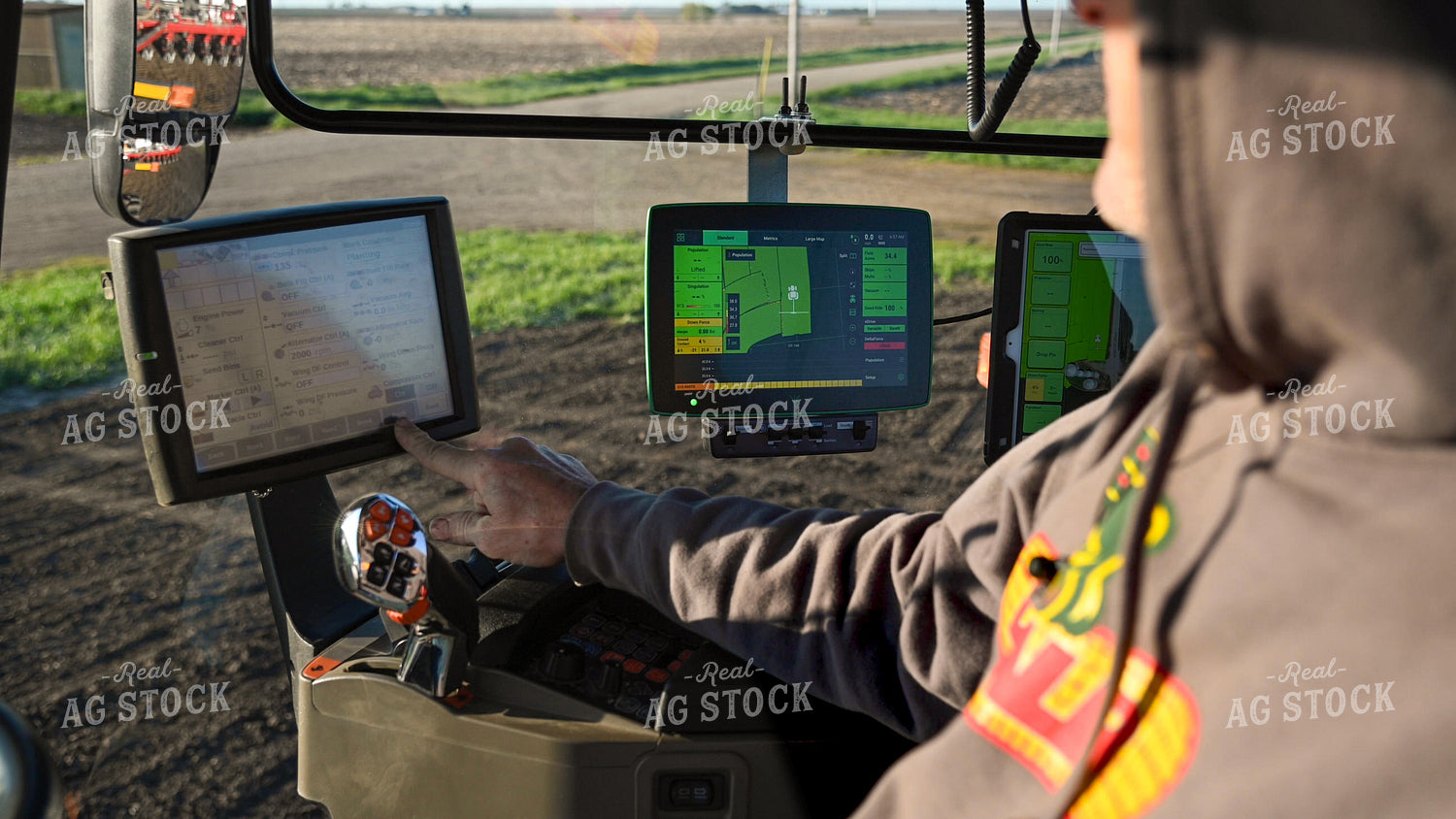 Farmer in the Tractor Cab with Technology 25184