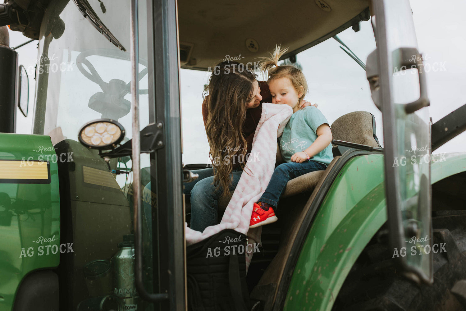 Female Farmer with Daugther in Tractor 8572