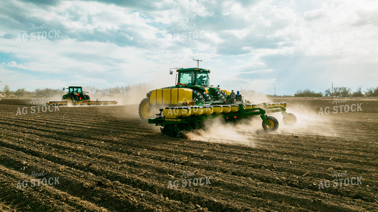 Tractor Rolls Field Ahead of Tractor Planting 56620