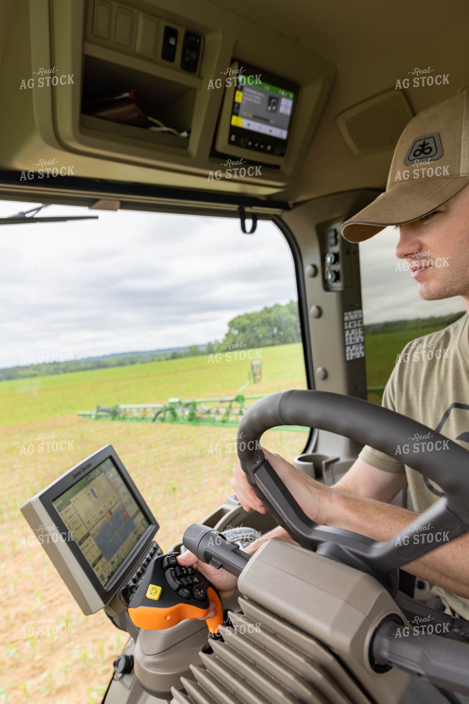 Farmer Driving Sprayer with Equipment Monitor Visible 79297