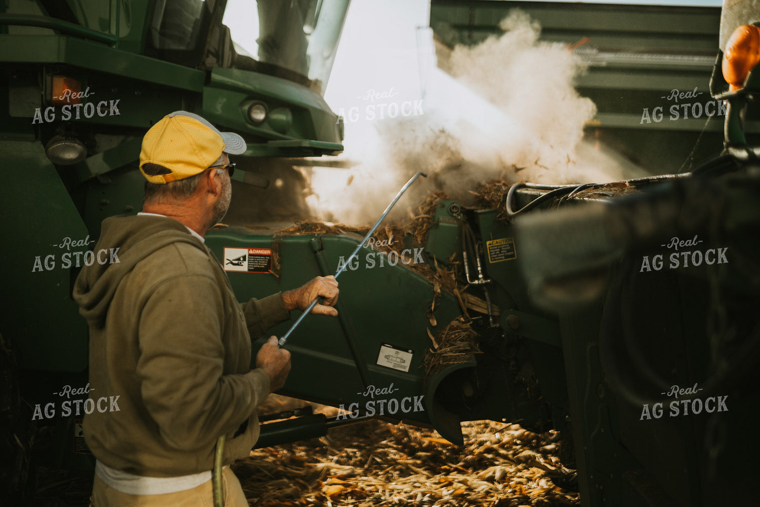 Farmer Cleaning Combine with Air Hose 4663