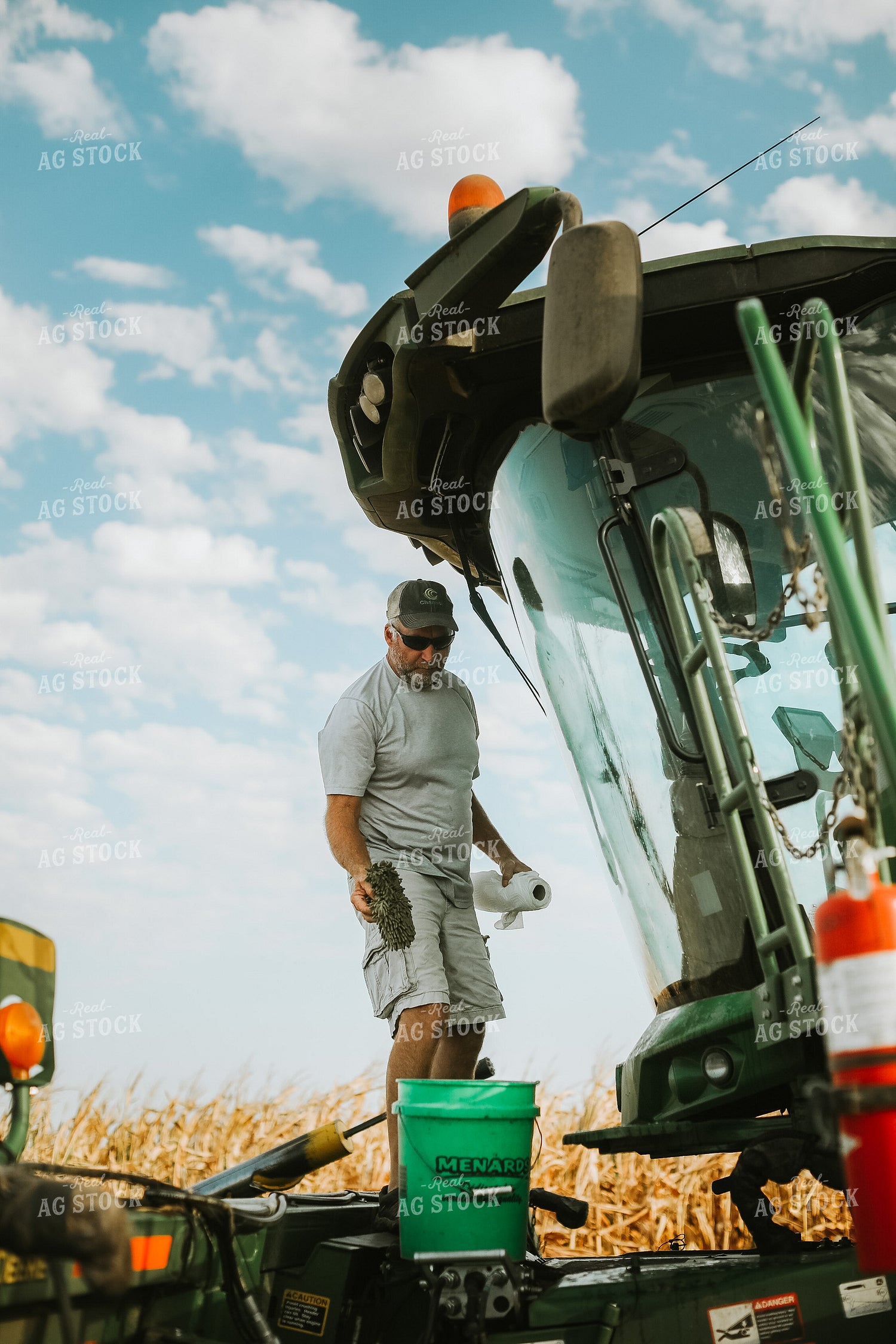 Farmer Working on Combine in Corn Field 5244
