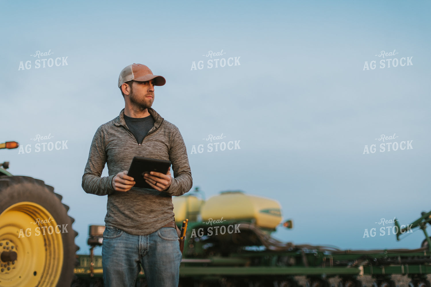Farmer using Tablet in Field by Planter 8254