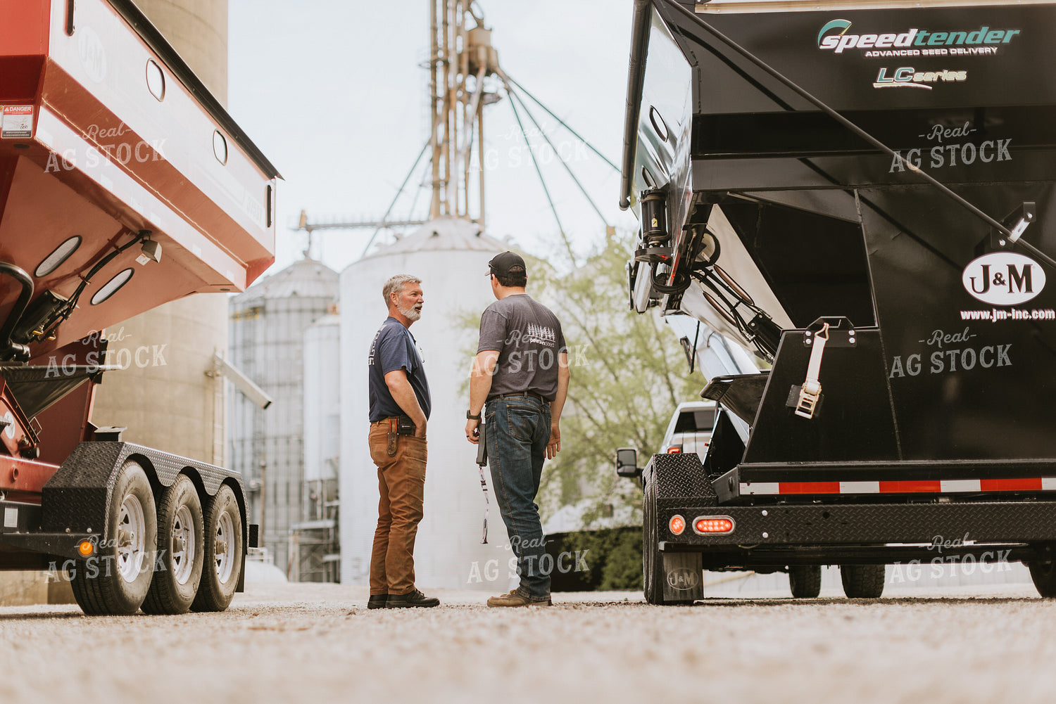 Farmers Talk in Front of Grain Bins 7597