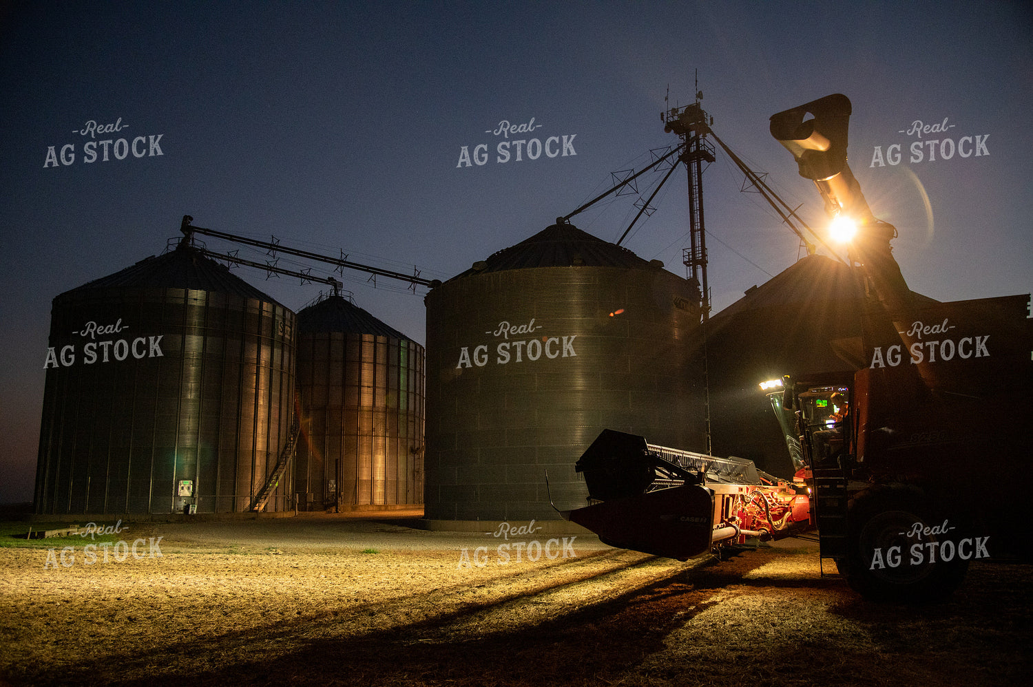 Farmer Sitting in Combine at Night 25802