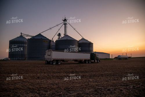 Semi Parked in Front of Grain Bin Site at Sunset 25798