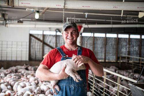 Farmer Holding Piglet 197011