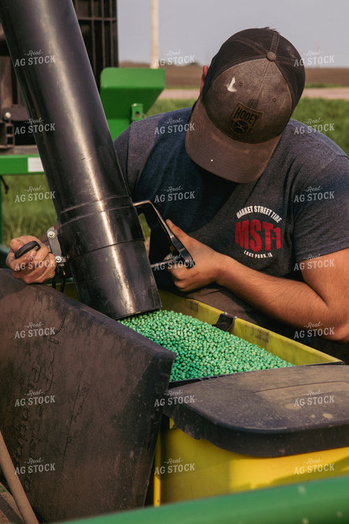 Farmer Loading Planter Boxes with Seed Tender 67315