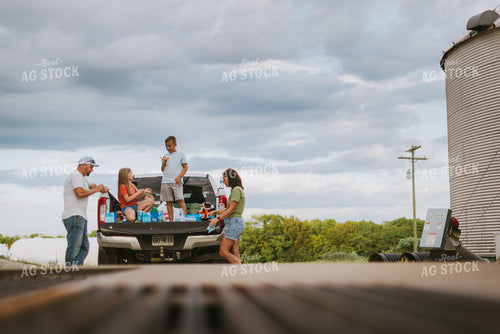 Farm Family Eating Dinner on the Tailgate 8757