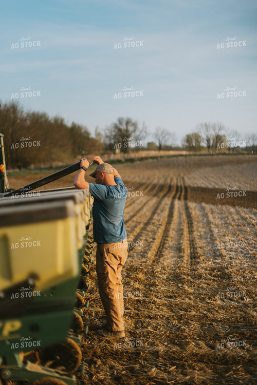 Farmer Checking Seed Box on Planter 7449