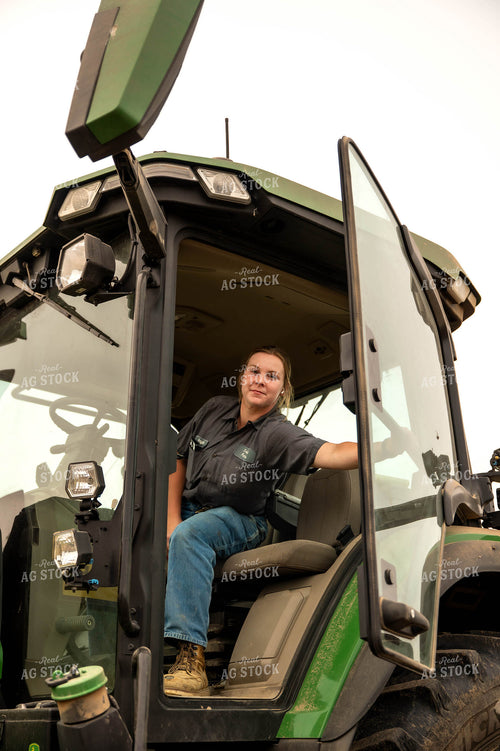 Female Farmer Climbing into Planter 115688
