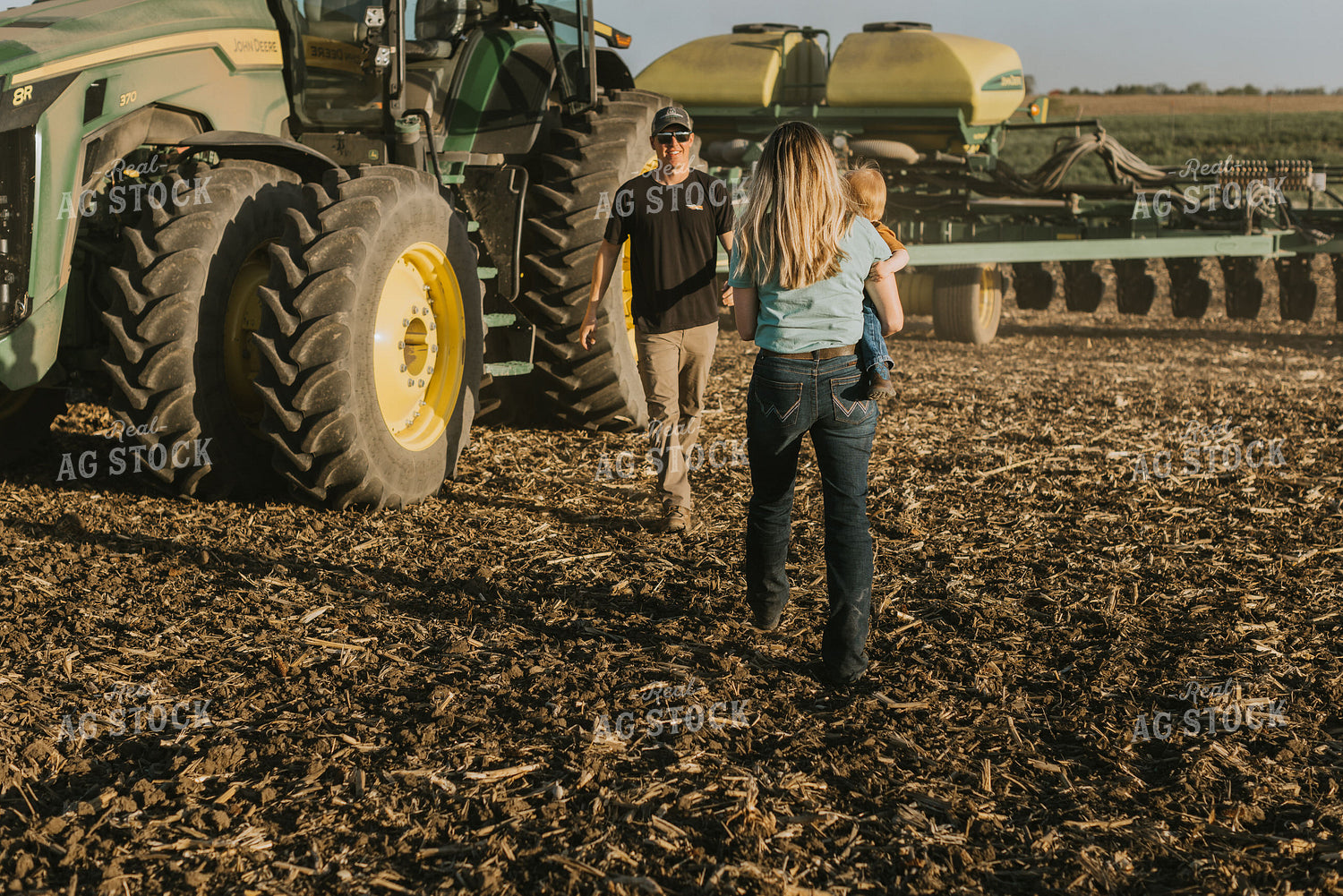Young Farmer Greeting Family in Field 7663